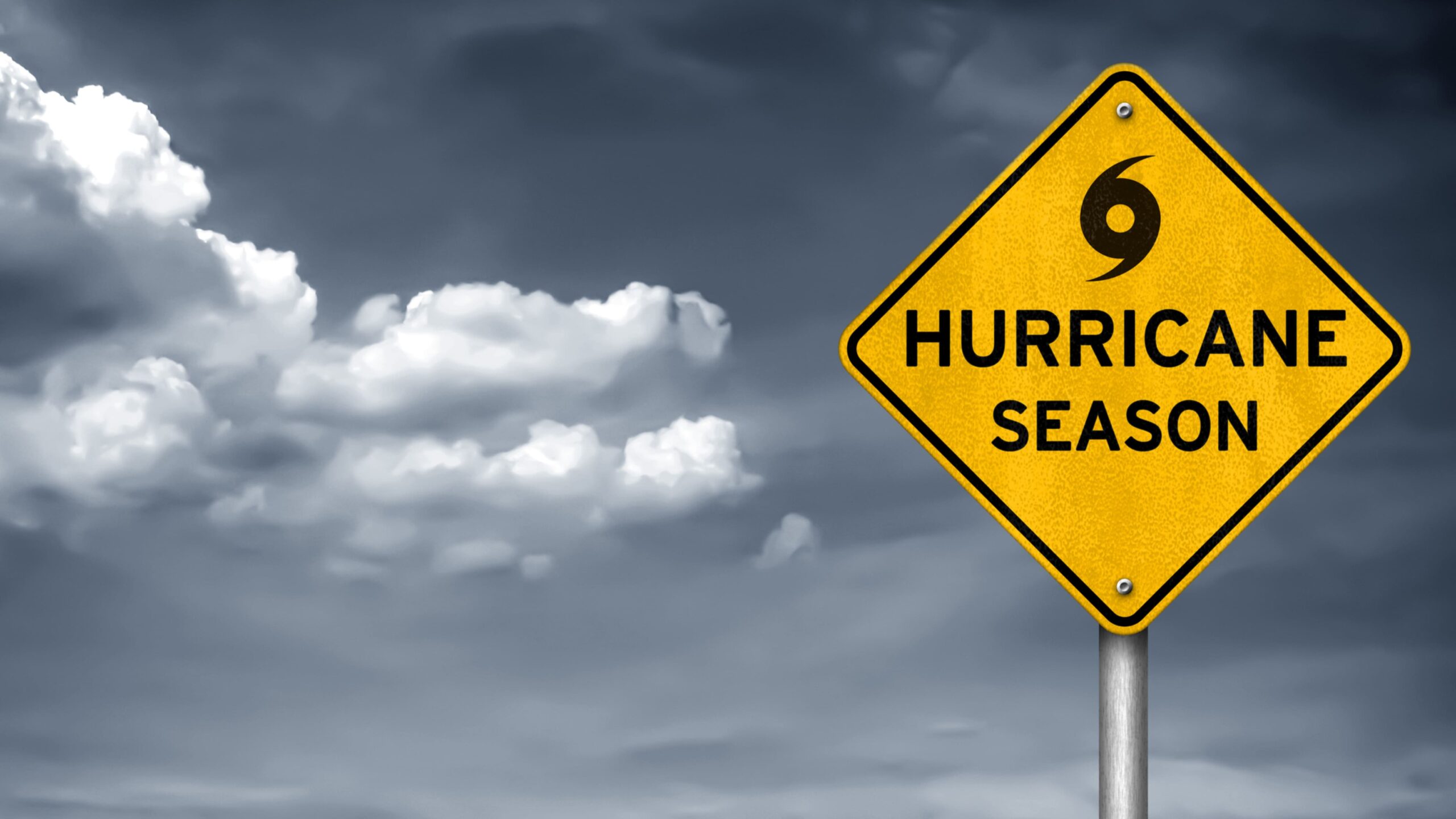 August 16th blog yellow hurricane season caution sign with stormy sky in the background
