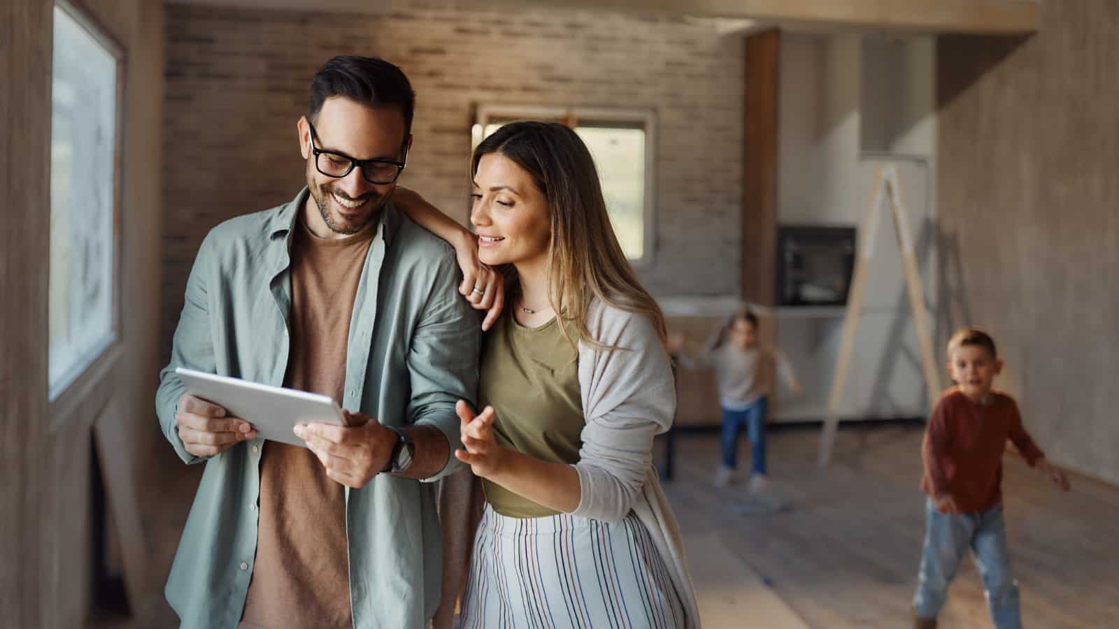 September 2nd Featured Image Young couple planning home renovation with children playing in background