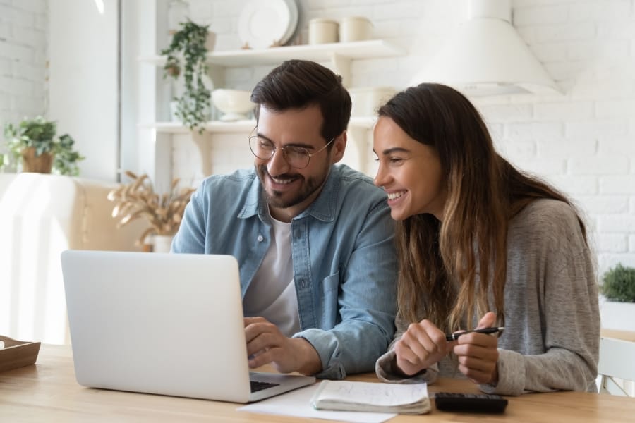happy couple on laptop